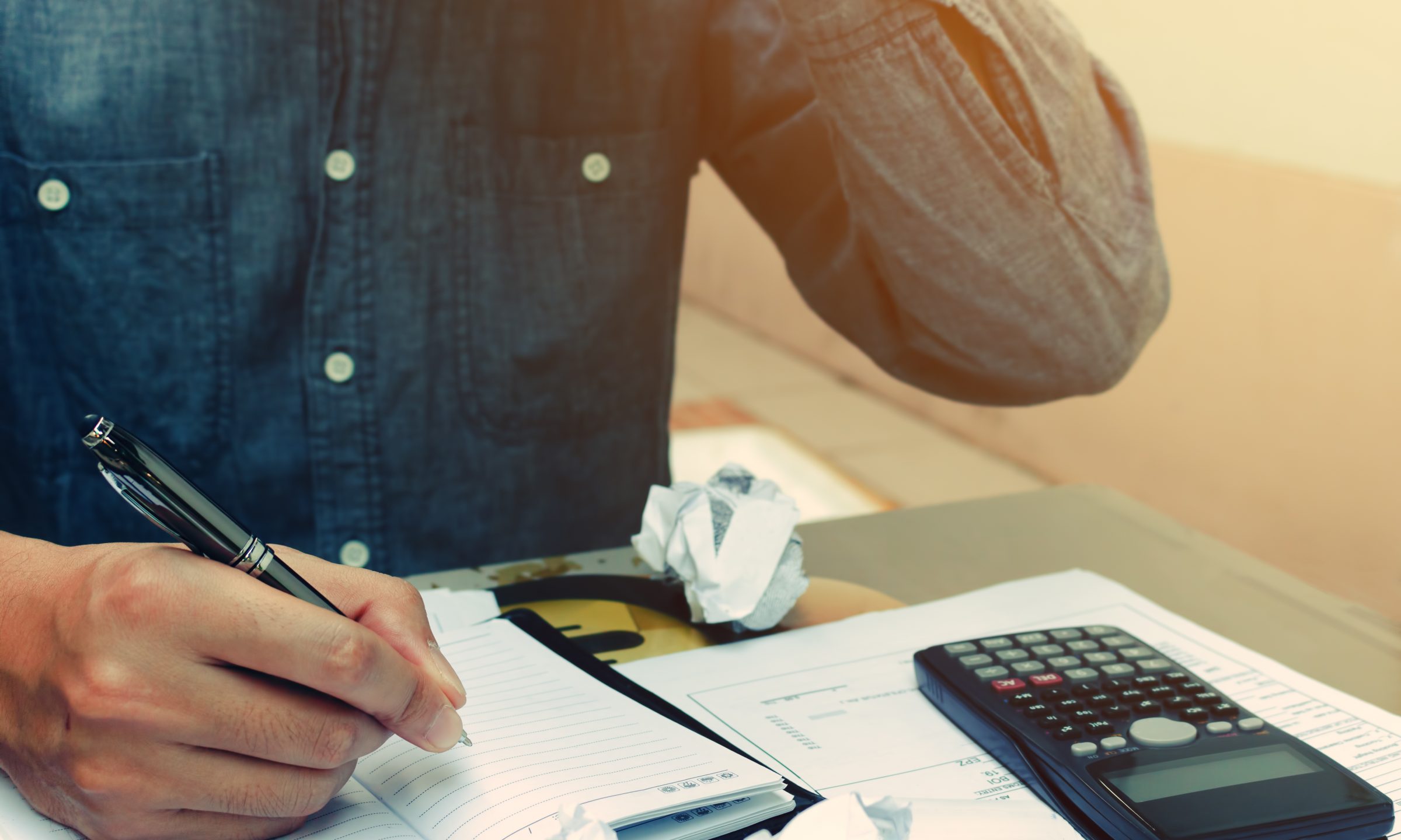Man counting using calculator and stress in problem with expenses.