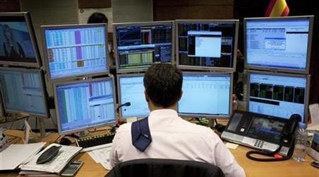 A trader looks at computer screens on the trading floor of Bankinter bank during a Spanish bond auction in Madrid September 20, 2012. REUTERS/Susana Vera
